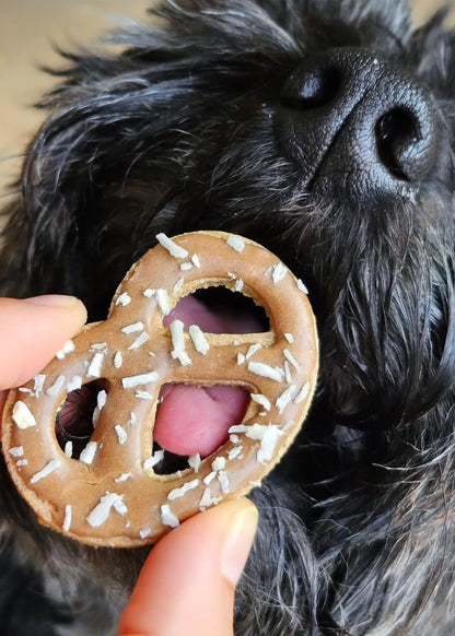 Hand-decorated pretzel dog biscuits with natural human‑grade ingredients