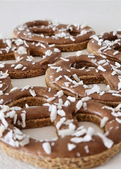 8 Pretzel Box dog cookies with carob and coconut decoration