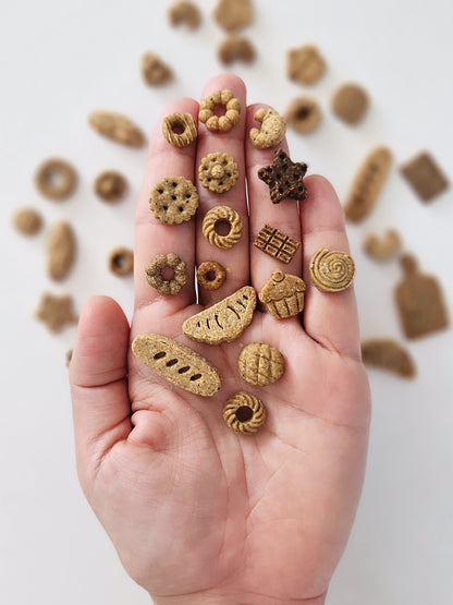 various small, baked dog treats shaped like different foods | minis for minis